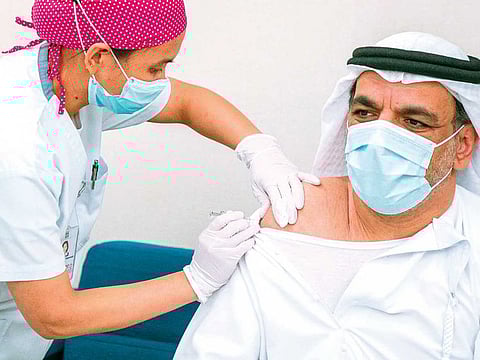 Dr Jamal Al Kaabi gets a shot of the trial vaccine.
