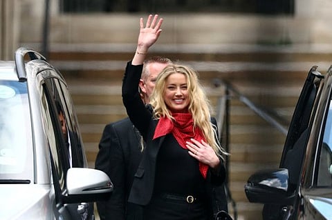 Actor Amber Heard waves as she leaves the High Court in London, Britain, July 16, 2020.