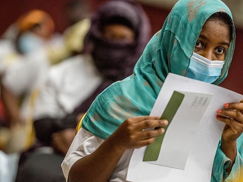 A Ghanian woman with her air ticket a day before her departure