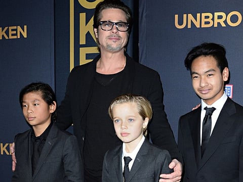 Brad Pitt and children Pax Jolie-Pitt (left), Shiloh Jolie-Pitt (centre) and Maddox Jolie-Pitt on December 15, 2014.