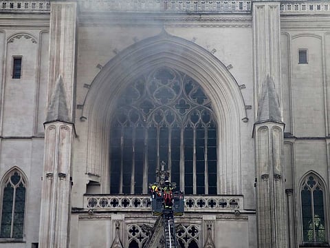 Fire fighters brigade work to extinguish the blaze at the Gothic St. Peter and St. Paul Cathedral, in Nantes, western France, Saturday, July 18, 2020.