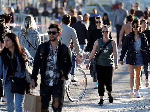 People walk at the walk side of Bondi Beach, as the state of New South Wales grapples with an outbreak of new cases of the coronavirus disease (COVID-19), in Sydney, Australia, July 20, 2020.