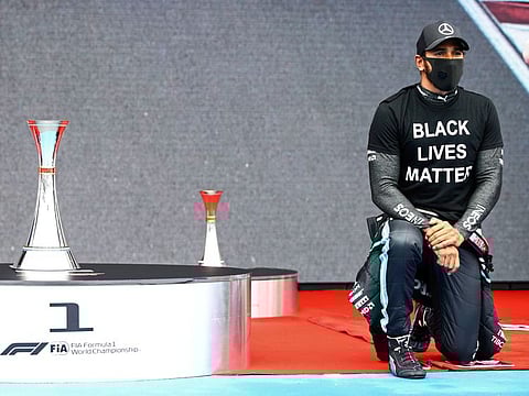 Lewis Hamilton, a six-time F1 world champion and the only black driver in the circuit, takes a knee after winning the Hungarian Grand Prix to lead the standings after three races.
