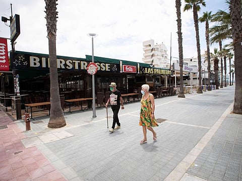 Tourists walk at Calle de la Cerveza (Bierstrasse) in Palma de Mallorca, at Spain's Balearic island of Majorca on July 16, 2020. Regional authorities on Spain's Balearic island of Majorca ordered the immediate closure of bars on three streets popular with hard drinking tourists to limit the potential for coronavirus outbreaks.