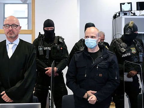 Accused Stephan Balliet, right stands next to his lawyers Hans-Dieter Weber, in the courtroom of the regional court at the beginning of the trial in Magdeburg, Germany, Tuesday, July 21, 2020.