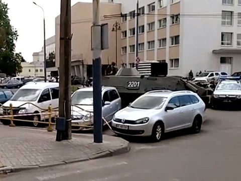 In this image take from video, the scene as streets are closed off, with an armoured security vehicle and police car, right, after an armed man seized a bus and took some 20 people hostage in the city centre of Lutsk, some 400km west of Kyiv, Ukraine on Tuesday July 21, 2020.