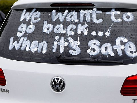 A message written on a car window is pictured as Florida teachers, whose unions are against their members returning to school, hold a car parade protest in front of the Pasco County School district office in Land O' Lakes, Florida, U.S. July 21, 2020.