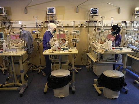 Neonatal intensive care unit nurses checks new born babies, at a governmental hospital, in Tripoli, north of Lebanon, Thursday, July 16, 2020.