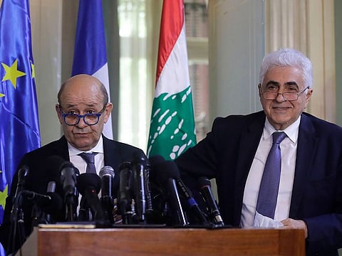 French Foreign Minister Jean-Yves Le Drian (L) and his Lebanese counterpart Nassif Hitti give a joint press conference in Beirut on July 23, 2020. - France's top diplomat was on a two-day visit to Lebanon in the first such trip in recent months by a high-ranking foreign politician to the crisis-hit country hoping for an international bailout