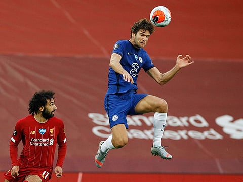 Chelsea's Marcos Alonso in action with Liverpool's Mohamed Salah