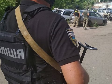 Ukrainian law enforcement officers are seen near a site where a man armed with a grenade holds a policeman hostage in Poltava, Ukraine July 23, 2020.
