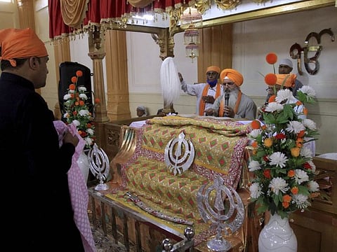 People of the Sikh community take part in worship at the Gurudawara Sri Guru Singh Sabha temple in Quetta, Pakistan, Thursday, July 23, 2020. The 200-year-old Sikh temple that served as a school for Muslim girls for seven decades was returned to the Sikh community in the city of Quetta, enabling them to worship there for the first time in 73 years, officials said Thursday.