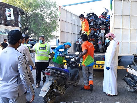 Officials with the seized cycles, bikes