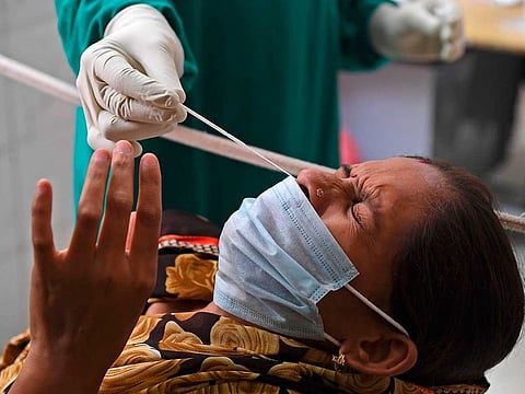 File picture: A medical staff collects a nasal swab of a woman with a Rapid Antigen Test (RAT) kit for the COVID-19 coronavirus, at a testing centre in Ghaziabad on July 23, 2020.