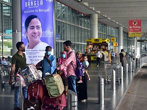 Passengers wearing protective face masks at Netaji Subhas Chandra Bose International Airport in Kolkata.
