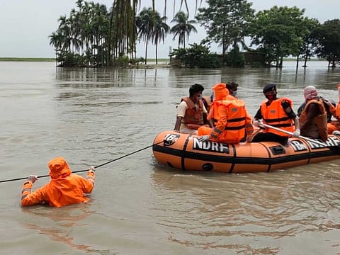 National Disaster Response Force personnel rescue villagers from flood-affected areas, in Barpeta on Sunday.