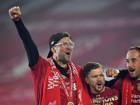 Liverpool manager Jurgen Klopp celebrates with his players after winning the Premier League.