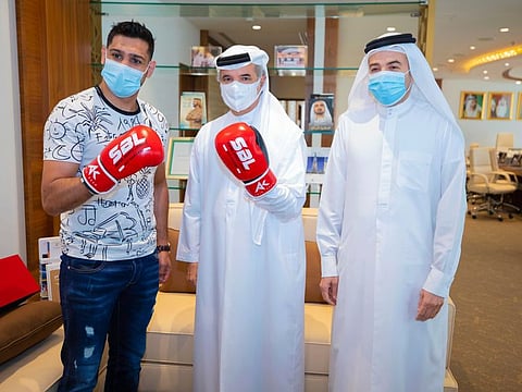 Amir Khan (left) and Saeed Hareb, Secretary General of Dubai Sports Council, strike a pose at the Dubai Sports Council premises. Nasser Aman Al Rahma, Assistant Secretary General, of the Council is also seen.