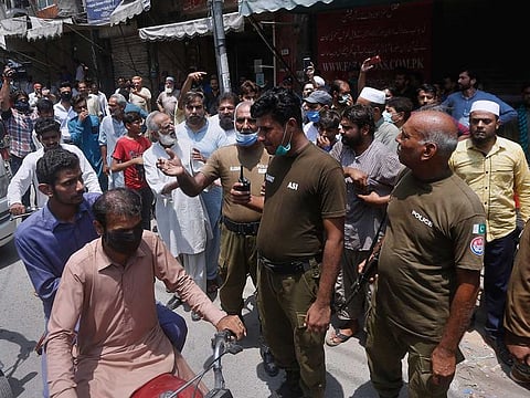 Police officers arrive at a market to ensure a lockdown imposed by the provincial government to help contain the spread of the coronavirus on the occasion of Eid Al Adha in Lahore, Pakistan, Tuesday, July 28, 2020.