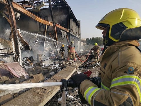 Firefighters from several fire stations brought the flames under control at the two warehouses in Dubai on Tuesday.