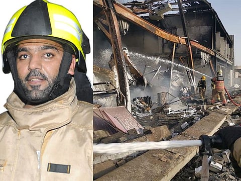 Left: First sergeant Adil Nasser Saleh. Right: Firefighters try to douse the blaze at the two warehouses in Dubai Investment Park on Tuesday.