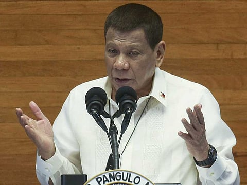 Philippine President Rodrigo Duterte gestures as he delivers his State of the Nation Address (SONA) at the House of Representative in Metro Manila