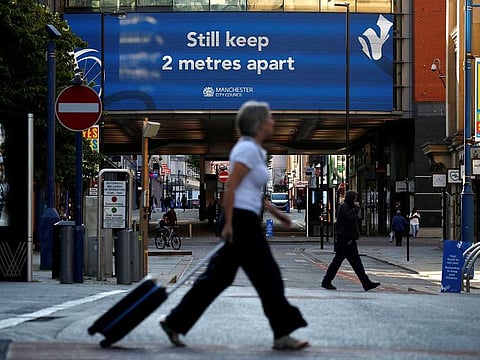 People maintain social distance as they walk through Manchester as the city and the surrounding area faces local restrictions in an effort to avoid a local lockdown being forced upon the area amid the coronavirus disease (COVID-19) outbreak in Britain, July 31, 2020.