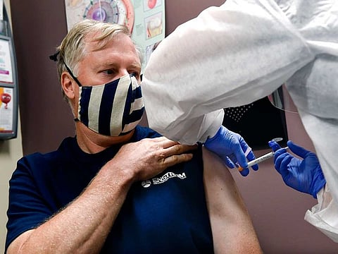 A volunteer  receives an injection as the world's biggest study of a possible COVID-19 vaccine, developed by the National Institutes of Health and Moderna Inc., got underway on July 27, 2020, in Binghamton, New York, US.