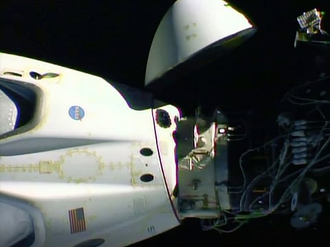 This NASA image shows the SpaceX Crew Dragon capsule, left, before it undocks from the International Space Station.