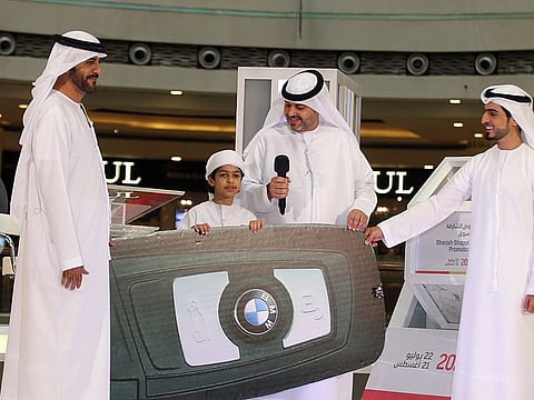 Officials from the Sharjah Chamber of Commerce & Industry with Salman Al-Ansari, one of the winners of the BMW X2.