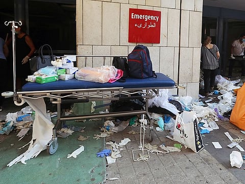 Protective gloves are scattered on the ground at a damaged hospital following Tuesday's blast in Beirut, Lebanon