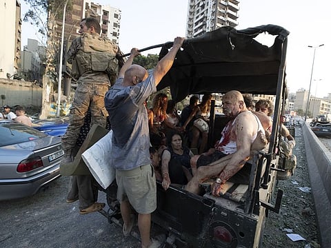 Injured people are evacuated after a massive explosion in Beirut, Lebanon, Tuesday, Aug. 4, 2020.