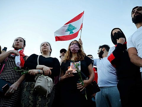 Lebanese come together for a vigil held at Kensington gardens in central London to honour the victims of the Beirut blast