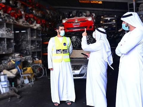 Sharjah Police inspect a shop selling scrap in the industrial areas.