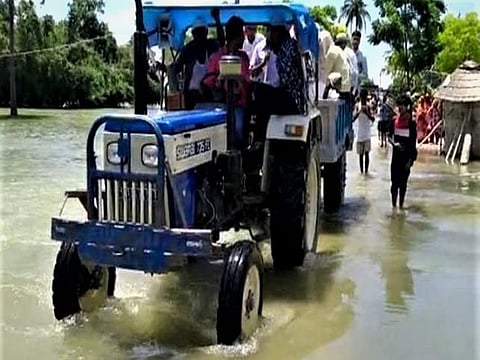 A groom had to hitch a ride on the back of a tractor to attend his wedding at a flooded Devkuli village in Bihar.