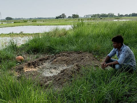 Mohammad Saiyub at his friend Amrit Kumar's grave in Devari village, Uttar Pradesh, where they grew up. (Vivek Singh/The New York Times)