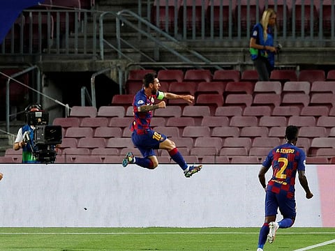Lionel Messi celebrates his strike for Barcelona against Napoli.