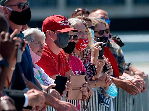 Supporters listen to US President Donald Trump's remarks on economic prosperity, at Burke Lakefront Airport in Cleveland, Ohio, on August 6, 2020.