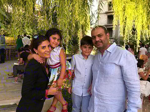 This August 19, 2019 photo provided by Soha Saade,, shows Soha and her husband Jihad with their children Gemma and Karl, in Miziara, north of Lebanon. Jihad died in his wife's hands while staying with their sick six-year-old daughter at a hospital in a massive explosion that devastated Beirut Tuesday.