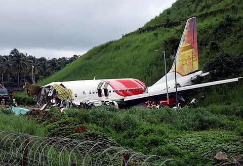 Wreckage of Air India Express flight at Kozhikode International Airport in Karipur on Saturday. 18 people including two pilots lost their lives when the Dubai-Kozhikode Air India flight (IX-1344) crash landed at Kozhikode International Airport on Friday night. (ANI Photo)