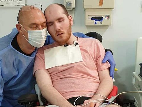 Naville Alberts with his son Tristan who has been diagnosed with traumatic brain injury and respiratory failure in Abu Dhabi..