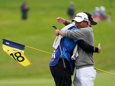 Collin Morikawa greets his caddie Jonathan Jakovac on the 18th hole at TPC Harding Park.