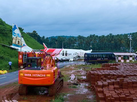 A man walks near the wreckage of the Air India Express jet at Calicut International Airport in Karipur, Kerala.
