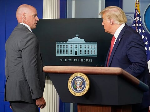 US President Donald Trump departs a news conference at the request of the Secret Service at the White House in Washington, Monday, Aug. 10, 2020.