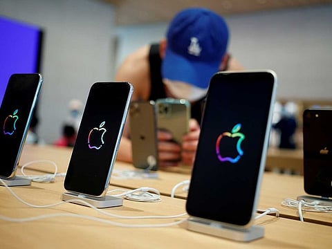 A man takes pictures of iPhones in the new Apple flagship store in Beijing.