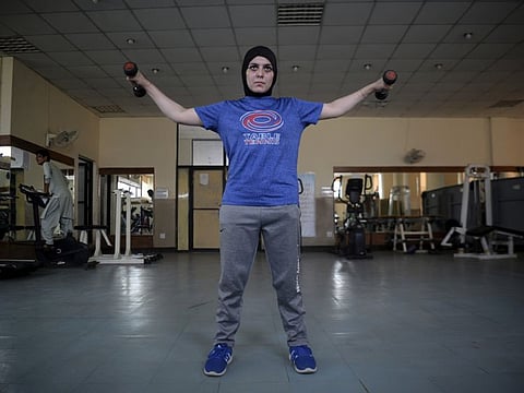 An athlete exercises at a gym following an ease in restrictions that had been imposed to help control the coronavirus, in Peshawar, Pakistan, August 10, 2020.
