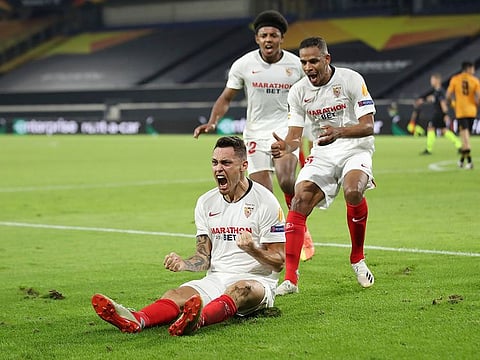 Sevilla's Lucas Ocampos, bottom left, celebrates with his teammates.