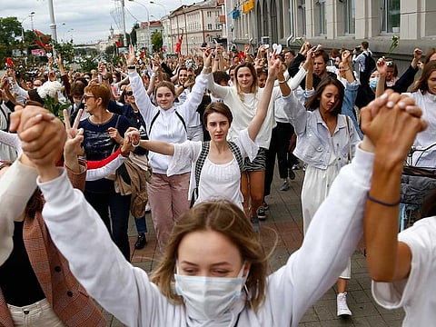 About 200 women march in solidarity with protesters injured in the latest rallies against the results of the country's presidential election in Minsk, Belarus, Wednesday, Aug. 12, 2020.