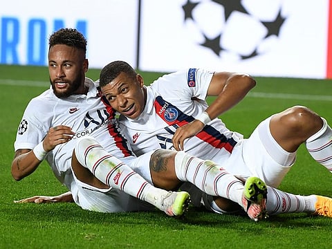 PSG's Eric Maxim Choupo-Moting, left, is congratulated by teammate Kylian Mbappe after scoring his team's second.