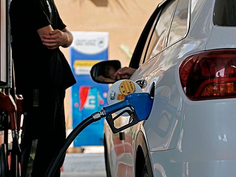 A Palestinian employee fills the tank of a car at a petrol station in Gaza City on August 13, 2020. - Israel attacked Hamas targets in Gaza and halted its fuel flow into the enclave, in the latest measures over a wave of airborne fire bombs from the Palestinian territory. The fuel sanction was "in light of the continued launching of incendiary balloons from the Strip toward the territory of the State of Israel and of the undermining of security stability", the defence ministry said